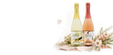 Two wine bottles with floral labels on a white background